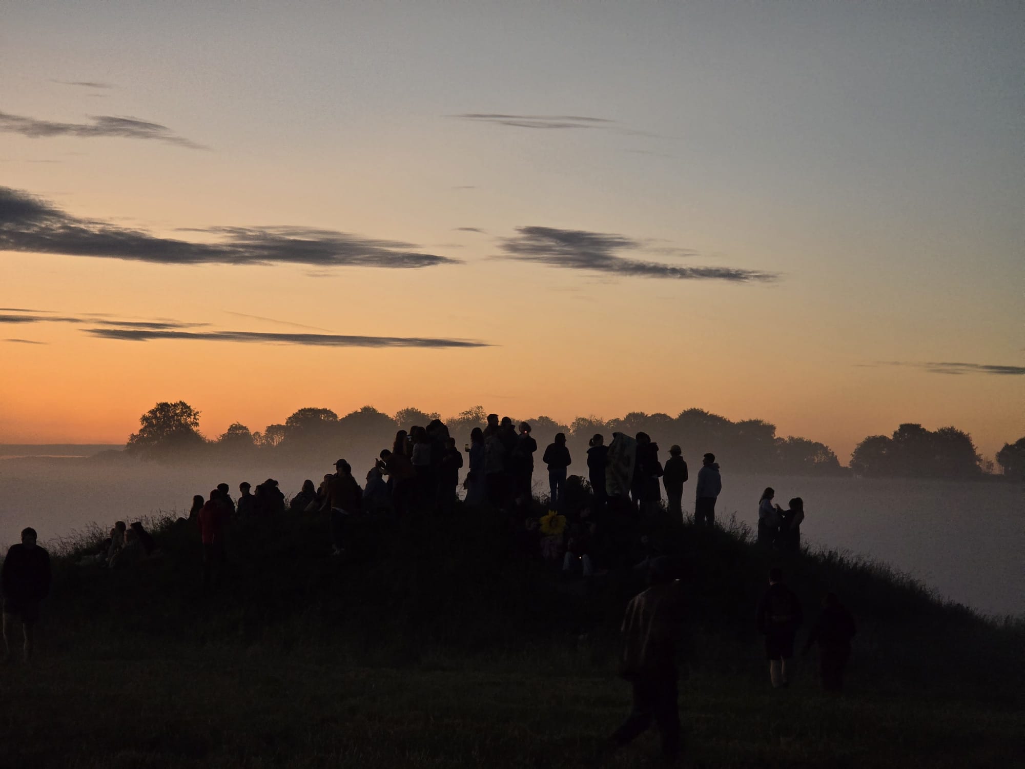 The group gathered on a hilltop above the morning mist
